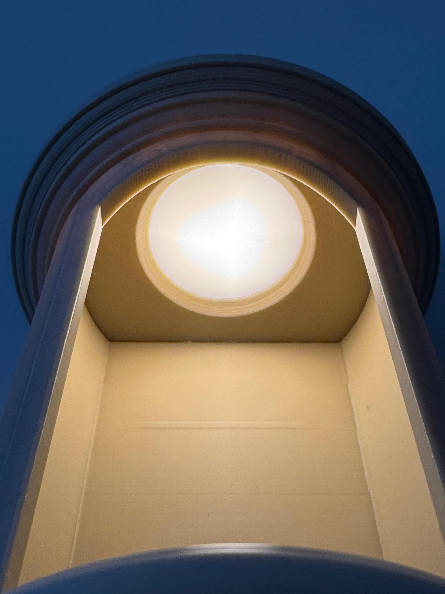 Close-up of a light fixture with a blue background