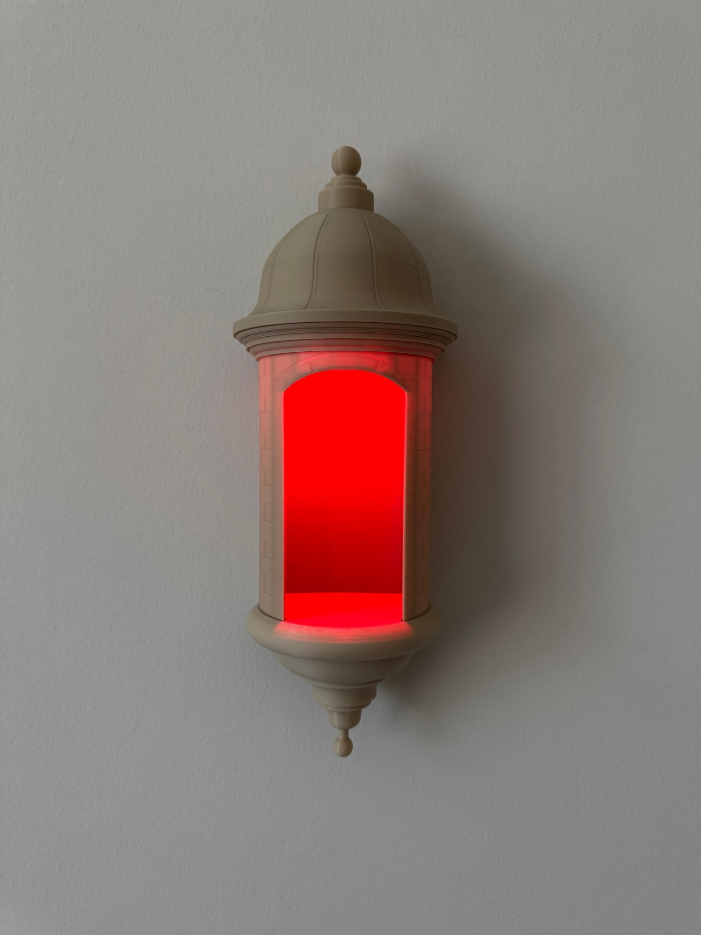 Decorative wall light with red interior on a plain background