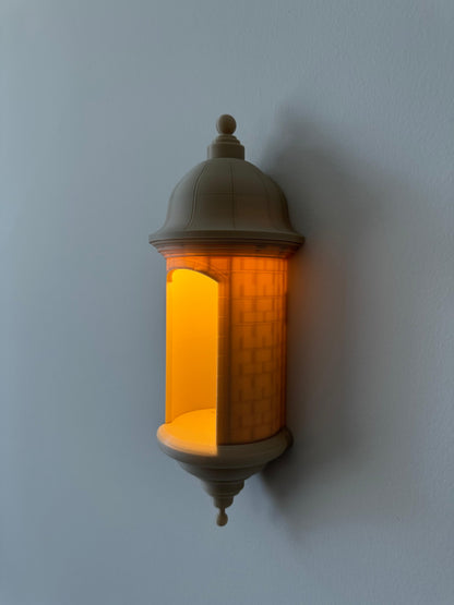 Decorative wall light fixture with warm glow on a plain wall