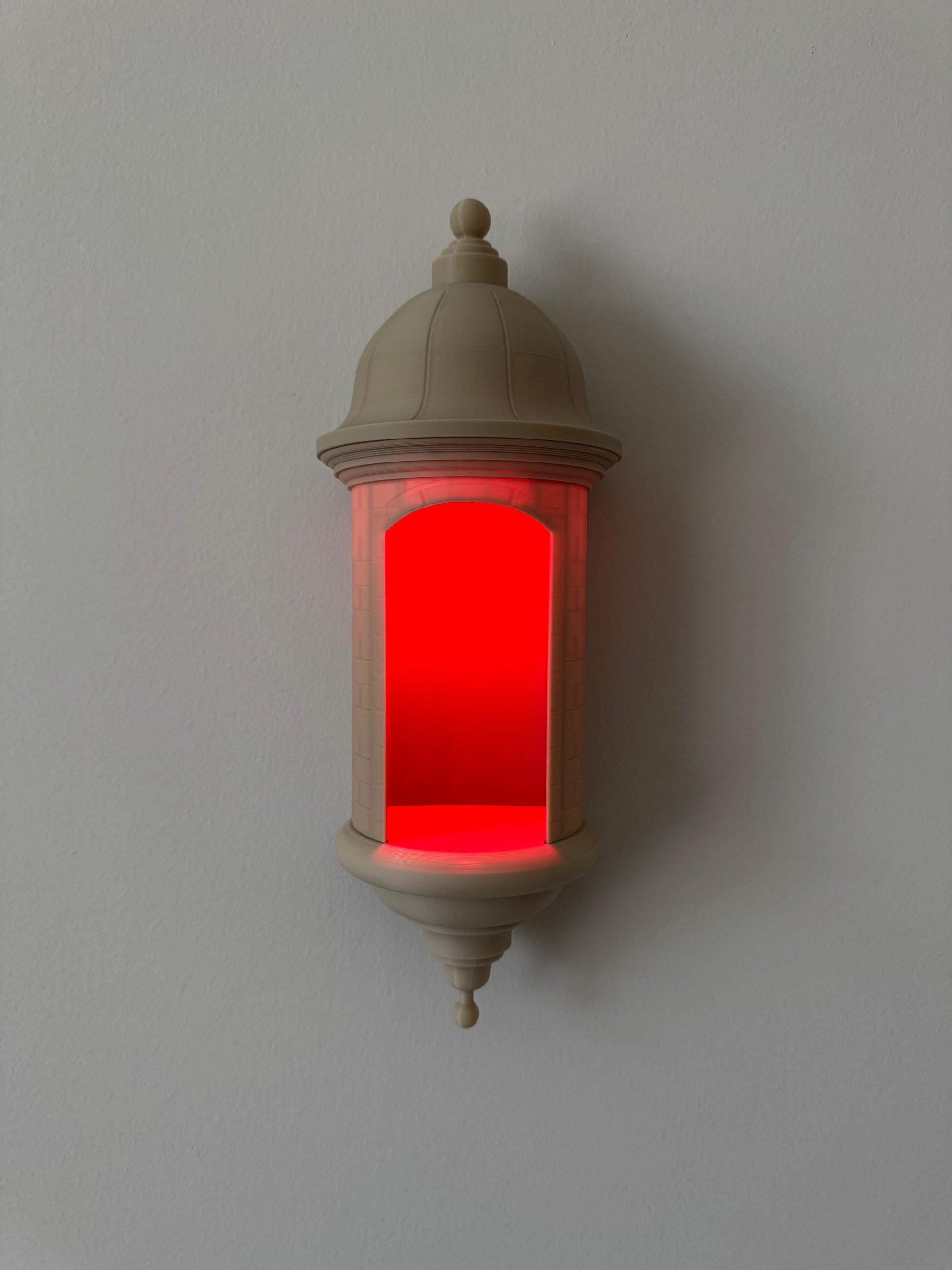 Decorative wall light with red interior on a plain background