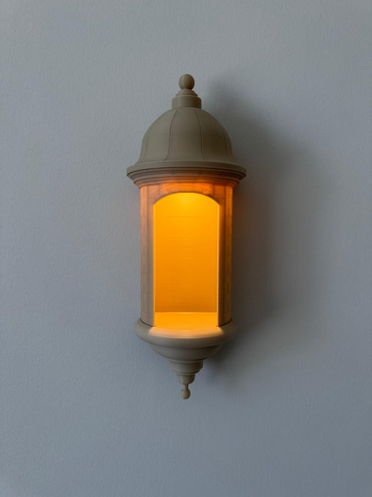 Decorative wall light fixture with warm glow on a plain wall